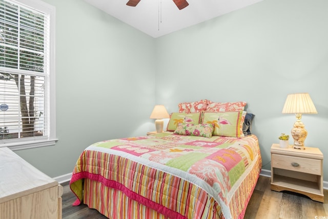 bedroom with ceiling fan and dark wood-type flooring