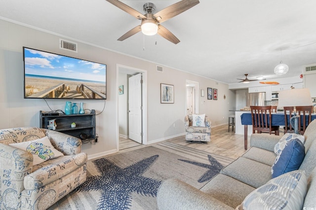 living room featuring ceiling fan, light hardwood / wood-style flooring, and ornamental molding