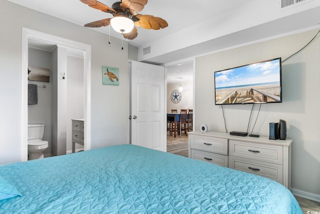 bedroom featuring connected bathroom, ceiling fan, and wood-type flooring