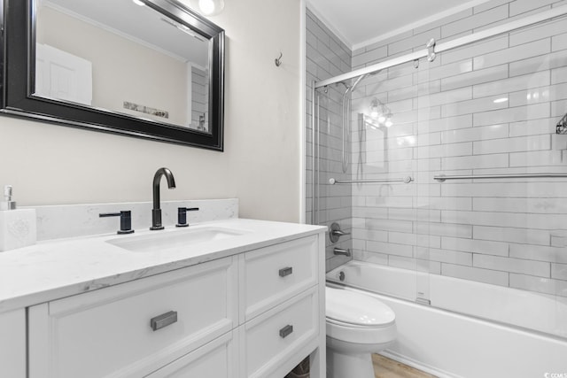 full bathroom featuring shower / bath combination with glass door, vanity, and toilet