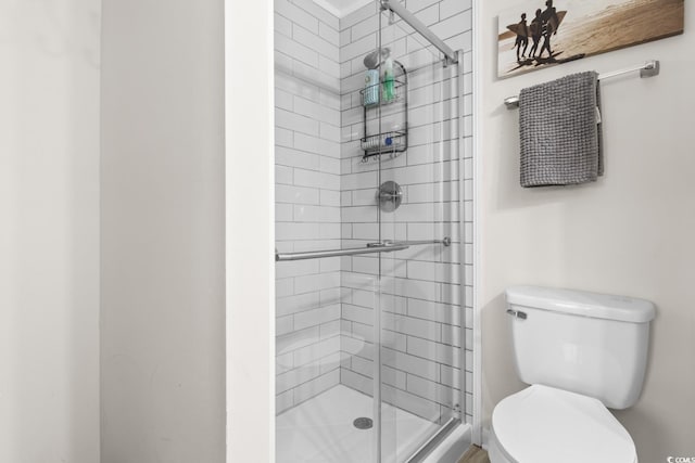 bathroom featuring an enclosed shower and toilet