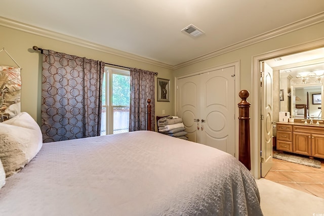 tiled bedroom featuring crown molding, sink, and ensuite bathroom