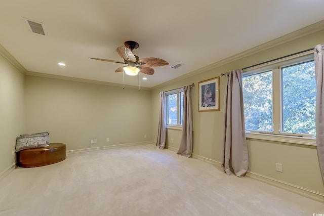 unfurnished room with crown molding, light colored carpet, and a healthy amount of sunlight