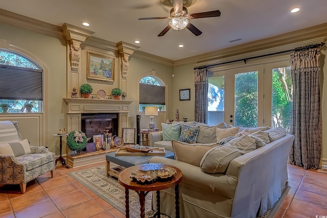 living room featuring crown molding, plenty of natural light, light tile patterned floors, and ceiling fan