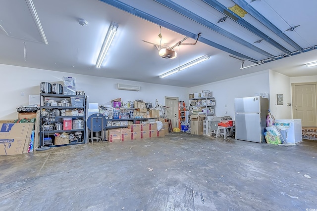 garage featuring stainless steel refrigerator, a garage door opener, and a wall mounted air conditioner