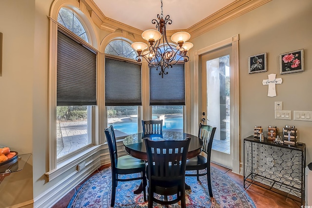 dining area featuring hardwood / wood-style floors, a notable chandelier, and crown molding