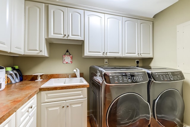 washroom with cabinets, separate washer and dryer, and sink