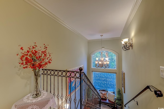 stairs with a chandelier and crown molding