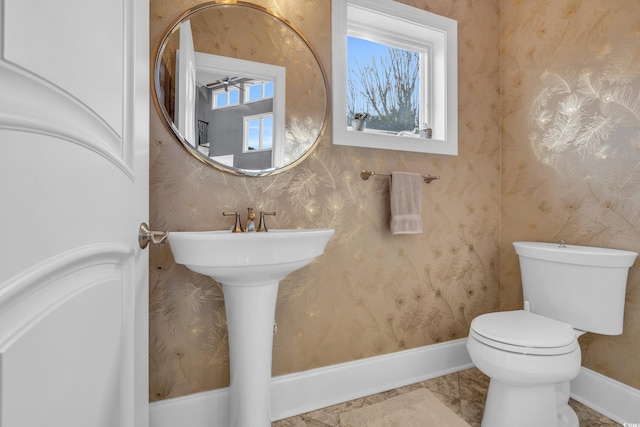 bathroom with toilet and ceiling fan