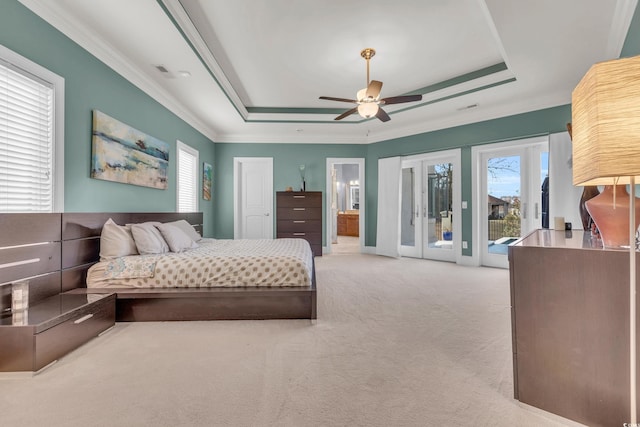 bedroom featuring a raised ceiling, ceiling fan, access to exterior, and light colored carpet