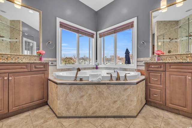 bathroom featuring tile patterned floors, vanity, independent shower and bath, and a healthy amount of sunlight