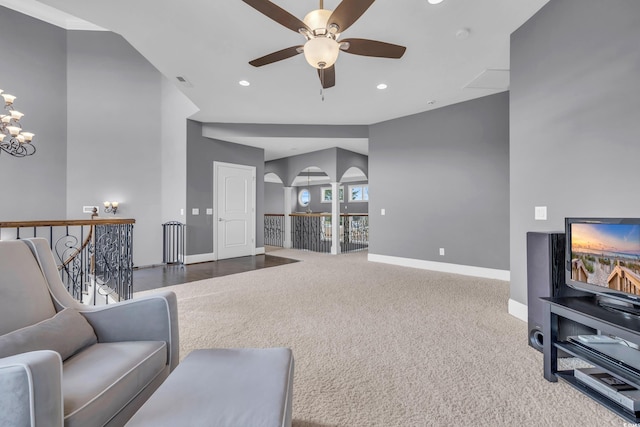 living room with carpet and ceiling fan with notable chandelier