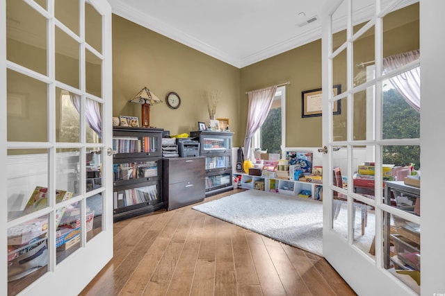 interior space featuring hardwood / wood-style floors, french doors, and ornamental molding