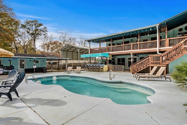 view of pool featuring a carport and a patio area