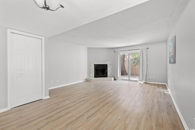 unfurnished living room featuring light hardwood / wood-style flooring and a fireplace