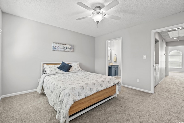 carpeted bedroom with ceiling fan, ensuite bath, and a textured ceiling