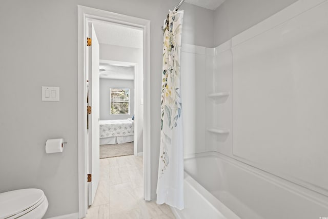 bathroom with shower / tub combo with curtain, toilet, and a textured ceiling