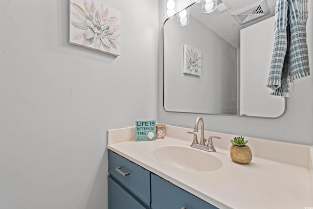 bathroom with vanity and a textured ceiling