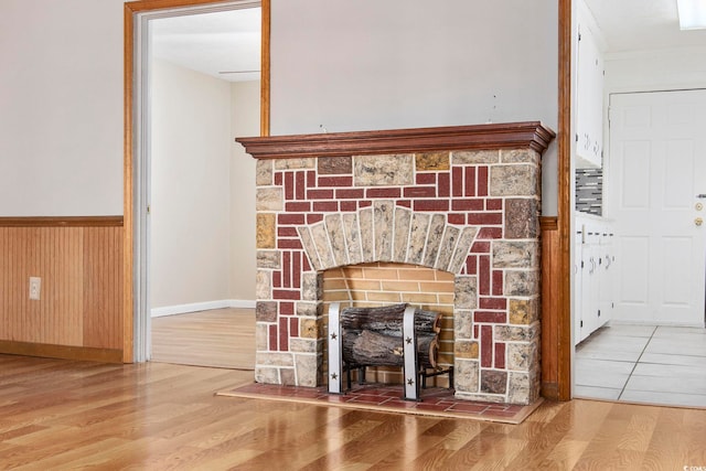 interior details featuring wood walls, a fireplace, and hardwood / wood-style floors