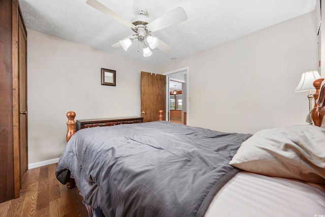 bedroom featuring ceiling fan and dark wood-type flooring