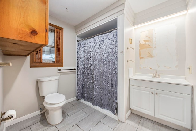 bathroom featuring vanity, toilet, and curtained shower