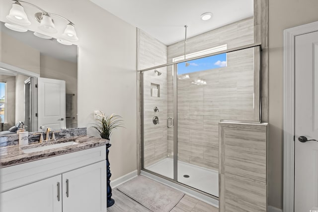 bathroom featuring vanity and an enclosed shower