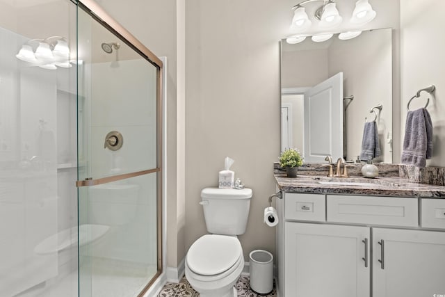 bathroom with tile patterned floors, vanity, an enclosed shower, and toilet