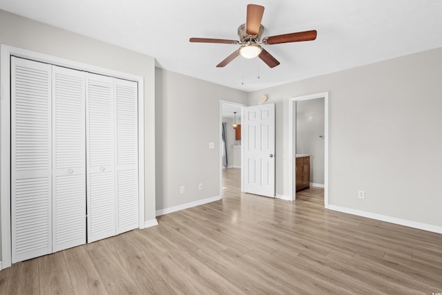 unfurnished bedroom with ceiling fan, a closet, ensuite bathroom, and light wood-type flooring