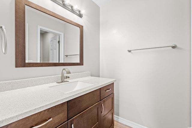 bathroom with vanity and hardwood / wood-style flooring