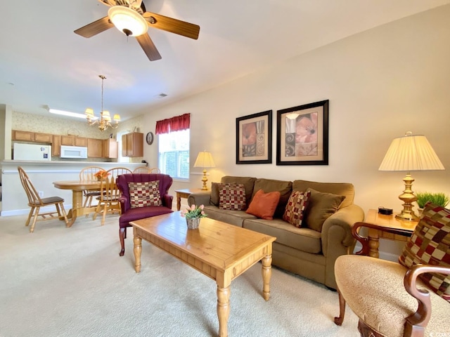 carpeted living room with ceiling fan with notable chandelier