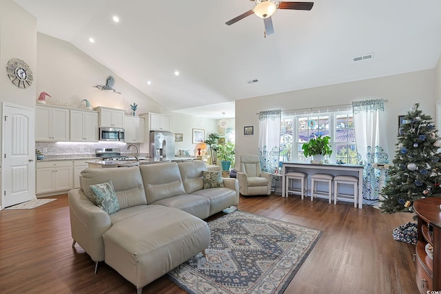 living room with ceiling fan, sink, dark wood-type flooring, and high vaulted ceiling