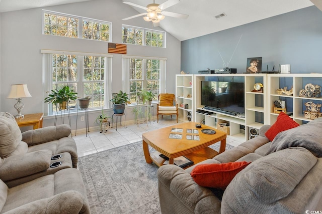 living room featuring ceiling fan, light tile patterned floors, and lofted ceiling