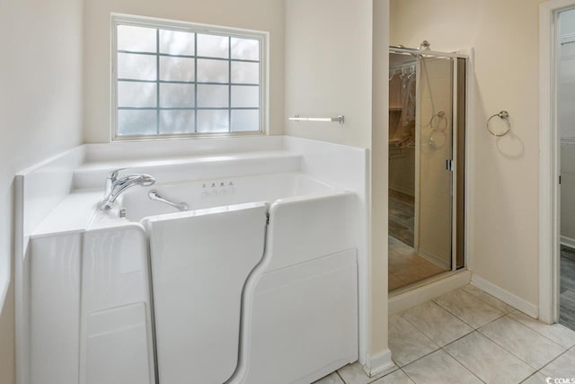 bathroom featuring tile patterned floors and independent shower and bath