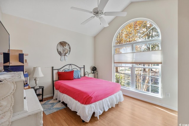 bedroom featuring light hardwood / wood-style flooring, ceiling fan, and lofted ceiling