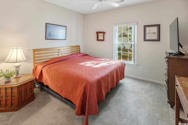 bedroom with ceiling fan and light carpet