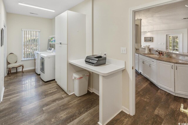 washroom with washing machine and dryer and dark hardwood / wood-style flooring