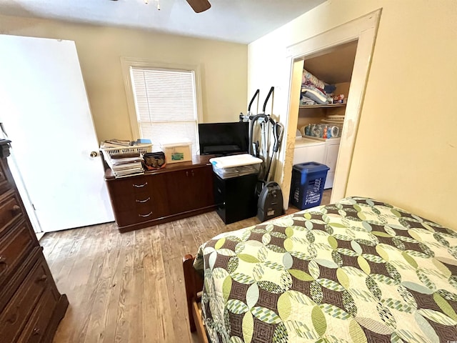 bedroom featuring washing machine and clothes dryer, ceiling fan, and light hardwood / wood-style floors