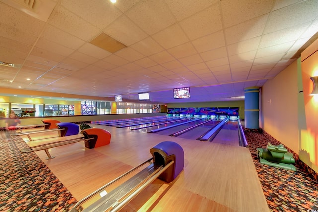 game room with a drop ceiling and a bowling alley