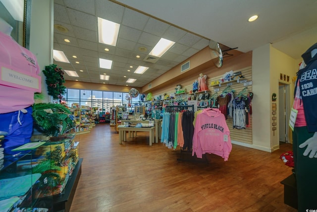 miscellaneous room featuring a drop ceiling and hardwood / wood-style flooring