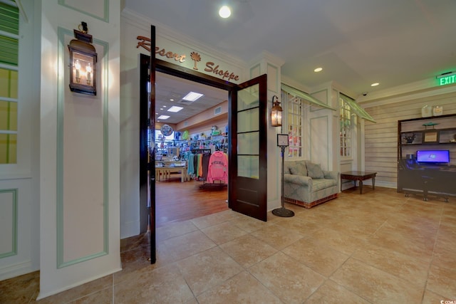 interior space featuring light tile patterned floors and crown molding