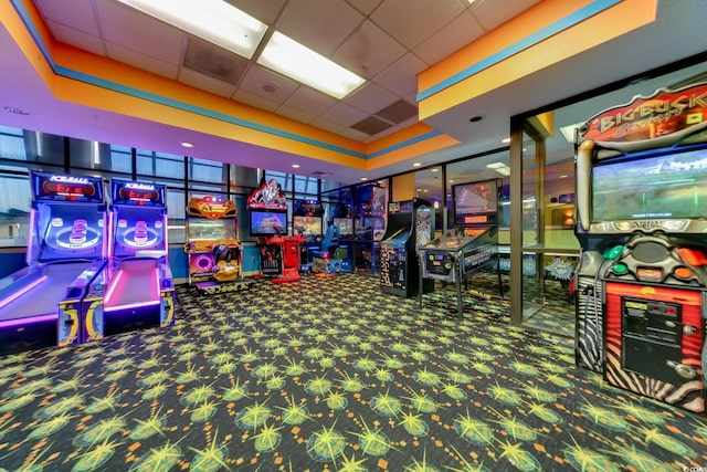 playroom with a tray ceiling, a drop ceiling, and carpet floors