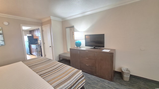 bedroom with ensuite bath, crown molding, and fridge