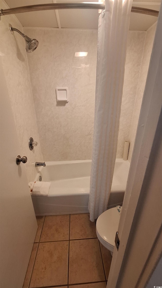 bathroom featuring tile patterned floors, toilet, and shower / tub combo with curtain