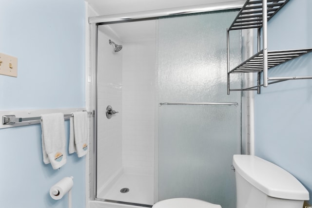 bathroom with toilet and walk in shower