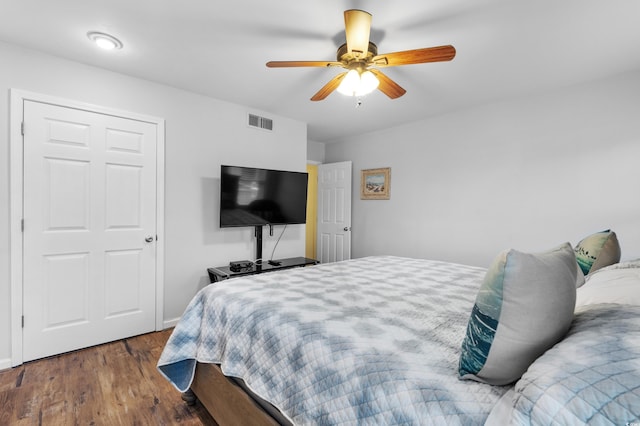 bedroom with ceiling fan and dark hardwood / wood-style flooring