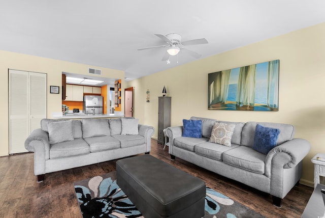 living room featuring dark hardwood / wood-style floors and ceiling fan