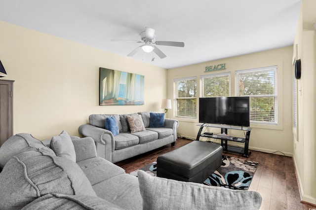 living room featuring a wealth of natural light, dark wood-type flooring, and ceiling fan