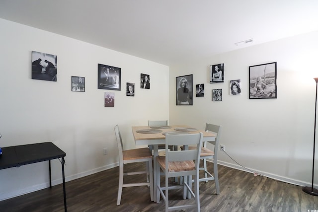 dining room with dark hardwood / wood-style floors