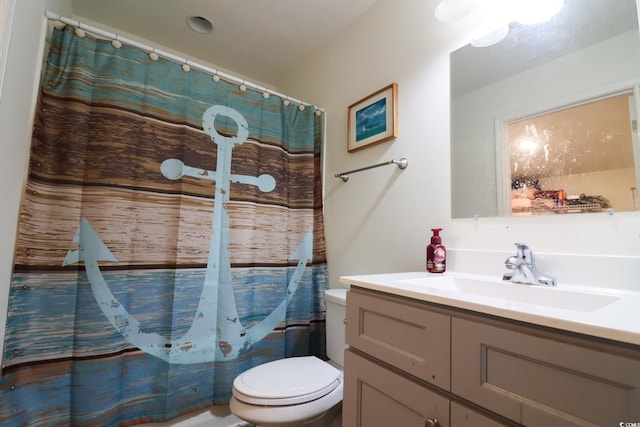 bathroom with vanity, a shower with shower curtain, and toilet