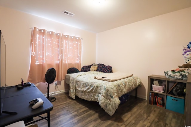 bedroom with dark wood-type flooring